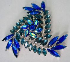 Unique Blue Brooches For Party, Unique Blue Brooch For Party, Unique Blue Brooches For Formal Occasions, Mid-century Blue Brooches For Gifts, Blue Vintage Brooch For Party, Mid-century Brooch Jewelry For Party, Mid-century Party Brooch Jewelry, Blue Mid-century Jewelry For Formal Occasions, Mid-century Blue Formal Jewelry