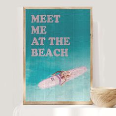 a poster with the words meet me at the beach on it next to a bowl