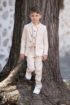 Boys linen summer suit for every casual or formal occasion include: Beige linen blazer features a single breast design with a button up front, two side pockets and jetted chest pocket, slim lapel, jacket sleeve buttons and hidden interior pocket. Classic high waisted  linen tapered leg pants with wide elastic waistband and side pockets.  Option to adjust the width of the kid's waist. Closure with zipper and button, 2 fake flap pockets on the rare. Soft long sleeves white linen polo shirt with chest pocket. Stylish classic single breasted vest with jetted chest pocket, fully lined. Dress up the smallest member of the family in a groomsman suit that is ideal for use at any formal or semi-formal occasions. Toddler boy slim fit summer suit is perfect for creating a stunning, completed look tha Formal Blazer Outfits, Rustic Wedding Outfit, Dress Shirt Outfit, Outfit Beige, Formal Blazer, Shirt Dress Outfit, Summer Suit, Linen Summer, Lapel Jacket