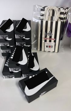 several black and white boxes sitting on top of a table next to a striped bag