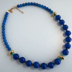 This Blue Agate necklace is an elegant design. Wear this beautiful blue and gold necklace with your light blue dress, or the green one, and you will shine. If you want to feel unique with this unique necklaces for women,  a blue beaded necklace you will. Measurements - 20.8 Inches  (53 cm), adjustable up to 22.4 inches (57 cm) Materials - Blue Agate gems. JADE beads. Goldplated brass.  Goldfield closure. All the jewelry in my shop is designed with love and handmade by me. They are packed careful Elegant Blue Crystal Necklaces With Gemstone Beads, Elegant Blue Gemstone Bead Crystal Necklace, Elegant Blue Crystal Necklaces With Round Beads, Elegant Blue Crystal Necklace With Round Beads, Elegant Blue Necklace With Round Beads, Elegant Blue Beaded Necklace With Gemstone Beads, Elegant Blue Beaded Necklace, Elegant Blue Beaded Necklaces With Natural Stones, Gold Necklace Unique