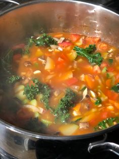 a pot filled with soup sitting on top of a stove