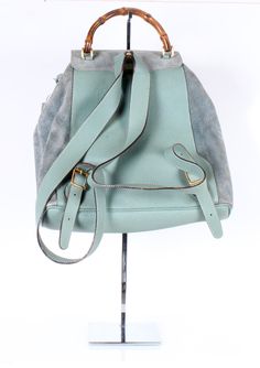 OR 4 interest-free installments of $93.75 USD by Sage green suede Gucci backpack w/ buckle and drawstring closures and two mini front pockets Dimensions: W 12 x H 13 x D 3 Condition: Good Gucci Backpack, Light Backpack, Gucci Bamboo, Green Suede, Sage Green, Light Blue, Buckle, Backpacks, Gucci