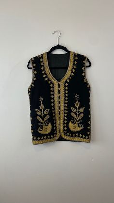 Made in Afghanistan, a rare find vintage sleeveless waistcoat. Hand embroidery on wool. A very antique piece in mint condition.  Size: S Measurements:  Height: 64 cm Chest: 47 cm Shoulder: 37cm Note: Worn and minor signs of wear. Festive Vest With Intricate Embroidery, Embroidered Festival Vest, Festive Sleeveless Vest With Intricate Embroidery, Embroidered Sleeveless Vest For Festival, Sleeveless Embroidered Vest For Festive Occasions, Festive Sleeveless Embroidered Vest, Festive Floral Embroidery Sleeveless Vest, Festive Floral Embroidered Sleeveless Vest, Vintage Embroidered Fitted Vest