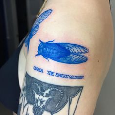 a woman with a blue tattoo on her arm