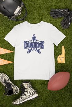 Looking for the perfect Cowboys Football T-shirt to show off your team spirit? Look no further! Our shirts are available in both black and white, making it easy to match your game day outfit. But what sets our shirts apart is the ability to customize the design. If you have any requests or ideas for changes, please reach out to us through the message box before placing your order. We want to ensure that you receive exactly what you're looking for. And if you're in search of a truly unique gift, we can also create a custom design just for you. From personalized gifts for Mom and Dad, to gifts for your boyfriend or husband on their birthday, we've got you covered. Our shirts also make great gifts for boys and football fans of all ages. Our shirts are perfect for vintage football enthusiasts, White T-shirt For Game Day Football Season, White T-shirt For Football Season Game Day, Football Season Fan Apparel T-shirt With Heat Transfer Vinyl, Football Fan T-shirt With Heat Transfer Vinyl, Sports Fan T-shirt With Team Name For Tailgating, Team Spirit Short Sleeve T-shirt For Tailgating, Crew Neck T-shirt With Team Logo For Cheerleading, Football Season Fan Gear T-shirt, Team Spirit Tops With Team Name For Tailgating