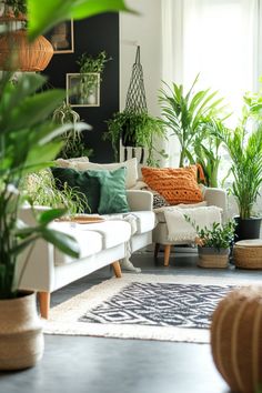 a living room filled with lots of plants and potted plants on top of white couches