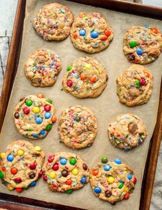 chocolate chip cookies with m & m's and sprinkles on a baking sheet