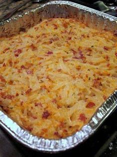 a casserole dish with cheese and bacon in it on a stove top, ready to be eaten