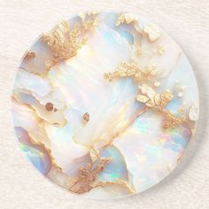 a white plate with gold leaf designs on it