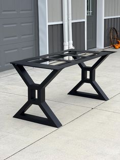 a black table sitting on top of a cement floor