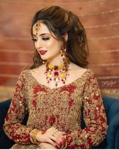 a woman in a red and gold outfit