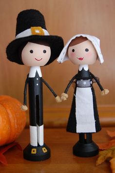 two dolls dressed in black and white holding hands