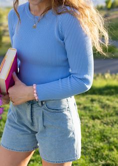 This is such a good go-to top for the spring and summertime. It looks so good on its own, but it's also amazing when it comes to layering with other pieces. The fit is stretchy, comfortable and flattering all at once! hal is 5'8 and wearing a size M size S: 18.5" length, 17" width size M: 18.5" length, 19" width size L: 19" length, 21" width width measurement = armpit to armpit while lying flat paired with the drawing hearts in the byline shorts this fabric is viscose and polyester with lots of Fitted Light Wash Top For Everyday, Fitted Knit Top For Spring Layering, Blue Knit Top For Spring Day Out, Fitted Knit Top For Spring Day Out, Solid Color Knit Top For Everyday Spring Wear, Chic Stretch Blue Knit Top, Feminine Light Blue Tops For Day Out, Spring Crew Neck Stretch Knit Top, Trendy Blue Knit Top For Day Out