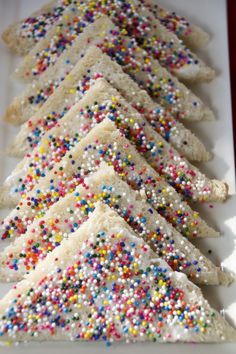 a white plate topped with cookies covered in sprinkles