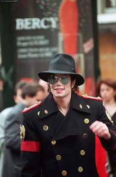 a man in uniform walking down the street