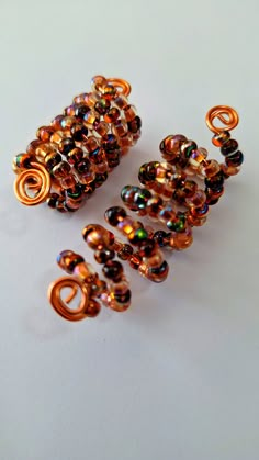 Loc Coil made with 4mm copper, Topaz, and gold glass seed beads on a copper coil.  Two sizes, 5 to 9mm for small locs, or 9 to 14mm, for medium to large locs.   Sold individually. Loc Accessories Black Women, Locs With Charms, Large Locs, Medium Locs, Small Locs, Dreadlock Jewelry, Chunky Twists, Dope Jewelry Accessories, Diy Beaded Rings