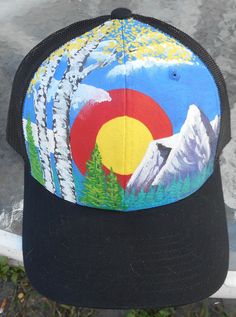 a trucker hat with the colorado flag painted on it's front and back