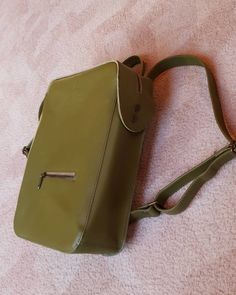 This moss colour genuine leather backpack is perfect accessory to your everyday city outfit. The colour is perfect for each season of the year.  It keeps it's strict form, so it can be perfect office backpack, where you can carry laptop, documents and all daily essentials here. #leatherbackpack #greenleatherbackpack #minimaliststyle #geometricbackpack #laptopbackpack Green Leather Satchel For School, Green Commuting Backpack With Adjustable Strap, Green Rectangular Leather Backpack For Daily Use, Rectangular Green Leather Backpack For Daily Use, Classic Green Backpack For Everyday, Leather Backpack With Adjustable Strap In Khaki, Khaki Leather Backpack With Adjustable Strap, Modern Green Backpack, Modern Green Leather Backpack For Travel