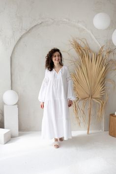 White cotton gauze dress, Loose bohemian dress, Muslin double gauze long dress, 100% Organic Cotton This stunning Bohemian style dress features a flowy silhouette, tiered skirt and balloon-style lace sleeves. The garment is crafted from organic cotton fabric - double gauze, making it light and airy. It is perfect for beach wedding, baptism party or any other occasion. Also comfortable and adorable for every summer day wear.  DETAILS: - lightweight breathable organic 100% cotton fabric - double gauze. - long loose flowy silhouette; - tiered ruffle skirt - long balloon form sleeves, with the elastic cuff; - sleeves decorated with cotton lace. - available in white and black.  BLACK color is HERE: https://www.etsy.com/listing/1476840795/black-cotton-gauze-dress-loose-bohemian?click_key=9a349de Flowy Bohemian Boho Dress For Daywear, Bohemian Maxi Dress For Daywear, Spring Cotton Dresses For Daywear, Spring Cotton Voile Day Dress, Spring Daywear Cotton Voile Dress, Bohemian Maxi Boho Dress, Flowy Boho Dress For Daywear, Flowy Linen Maxi Dress For Daywear, Bohemian Maxi Dress For Daywear With Relaxed Fit