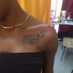 a woman with a tattoo on her chest that says valen in cursive writing