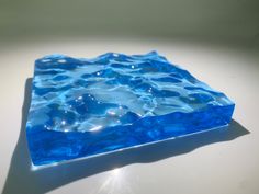 a blue glass plate sitting on top of a white table