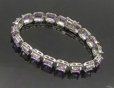 925 Sterling Silver - Prong Set Shiny Amethyst Hinge Chain Bracelet - BT7354  925 Sterling Silver - Prong Set Shiny Amethyst Hinge Chain Bracelet - BT7354  Jewelry Type:         Bracelet   Metal Type:            925 Silver  Metal Size:             7.5" Length  .25" Height   Stone Type:            Amethyst   Condition:              N/A  Jewelry Weight:     21.2 Grams  PLEASE NOTE: THIS ITEM IS PRE-OWNED. ALTHOUGH MOST ITEMS ARE IN VERY GOOD CONDITION, SOME MAY NEED CLEANING AND/OR MINOR REPAIRS. WE MAKE A VERY STRONG EFFORT TO UPLOAD CLEAR PICTURES. PLEASE INSPECT ALL PICTURES AND ASK ALL QUESTIONS YOU MAY HAVE PRIOR TO MAKING A PURCHASE. NOT ALL STONES ARE GENUINE, SOME ARE ENHANCED OR CREATED. Silver Gemstones With Jewels In Fine Jewelry Style, Elegant Silver Gemstones With Jewels, Anniversary Bracelet With Gemstone Accents, Formal Silver Amethyst Bracelet, Amethyst Bracelet In Fine Jewelry Style, Purple Jewelry With Jubilee Bracelet For Anniversary, Purple Fine Jewelry Bracelet, Amethyst Bracelet Fine Jewelry, Luxury Purple Rectangular Jewelry