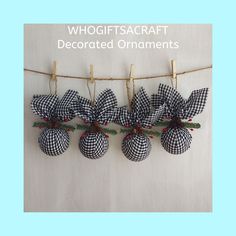 three ornaments hanging on a clothes line with the words whoifsacraft decorated ornaments