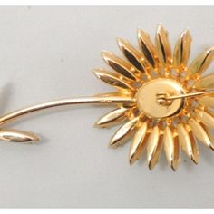 Goldtone prong set white cabochon and marquise rhinestone daisy brooch with security clasp. Marked "Napier" in tiny letters on the back of the stem. Circa 1964. Measures: 3 7/8 inches long by 1 5/8 inches wide. Excellent condition. The matching earrings with white and red rhinestones are shown on pg. 371 of Melinda L. Lewis & Henry Swen's book "The Napier Co.: Defining 20th Century American Costume Jewelry." American Costume, Napier Jewelry Vintage, 1960s Sounthern Vintage Earrings Jewelry, Chanel Flower, 1960 Jewelry, Vintage Yellow Gold Flower Brooches, Bakelite Brooch, Vintage Gold-tone Jewelry Brooch, Vintage Multi-stone Gold Brooches