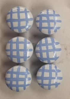 four blue and white checkered ceramic knobs