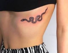 a woman with a snake tattoo on her stomach