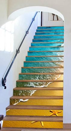 the stairs are painted with different colors and designs on them, as well as an ocean wave