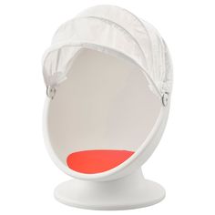 an egg chair with a white cover on it's back and red seat cushion