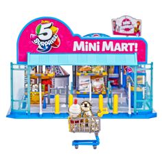 a small toy shopping cart in front of a mini martet store with lots of items