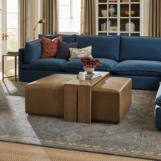 a living room with blue couches and coffee table