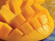 sliced mangoes on a blue and white plate