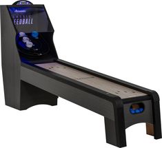 an arcade game machine that is black and has blue buttons on the front, while it's built into a wooden table