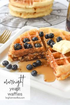 blueberry waffles with syrup and butter on a plate