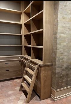 a room with some shelves and stairs in it