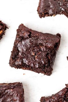 chocolate brownies cut in half on a white surface