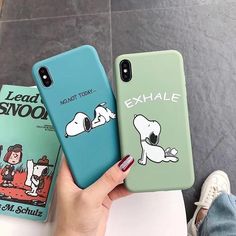 two cases with cartoon characters on them, one is green and the other is blue