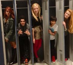 four girls and two boys standing in lockers