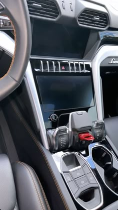 the interior of a car with steering wheel controls and center console, including an automatic gear box