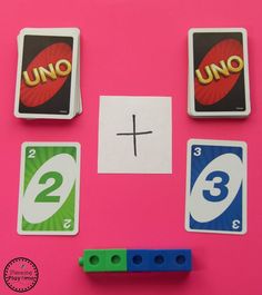 three matching cards with numbers and symbols on pink background