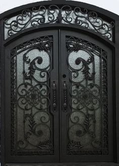 an ornate iron door with glass panels on the front and side doors, in black