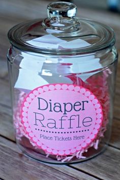 a glass jar filled with pink paper raffle