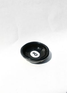 a black bowl sitting on top of a white table