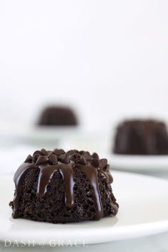 a chocolate mini bundt cake on a white plate with the words triple chocolate mini bundt