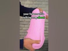 a person holding a pink object with the words, your future self is taking crap about