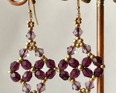 The list is for the first and second picture.
This beautiful earrings it was features with PRESTIGE Tanzanite beads, Amethyst Czech beads, and gold seed beads. The earwires are 14Kt Gold filled. 
Earrings measure about 1 1/2" in total length from the top of the earwire.The material used for this earrings are:
 PRESTIGE Crystal beads
 Toho seed beads
 14Kt Gold Filled wire, beads and chain.They are much more beautiful than in the photo.Thanks for looking. If you have any questions, please contact Gold Filled Earrings, Birthstone Earring, February Birth Stone, Czech Beads, Purple Gold, 14kt Gold, Beautiful Earrings, Crystal Beads, Beaded Earrings